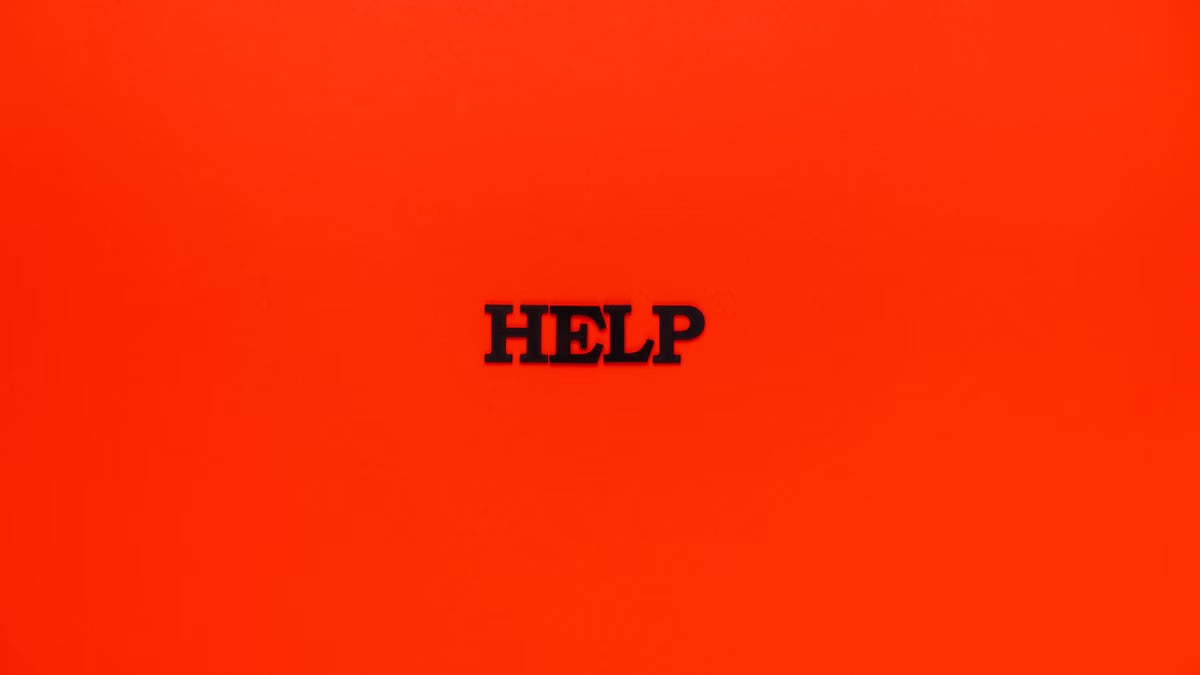 Minimalist red background featuring the word 'HELP' in bold text.